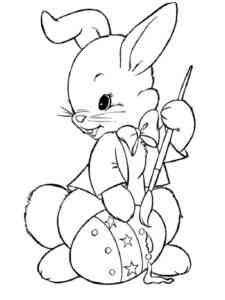 Easter Bunny paints an egg coloring page